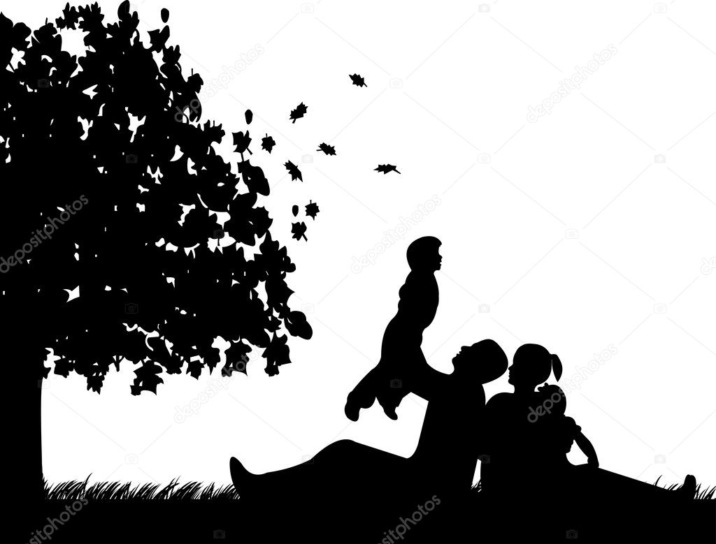 Family picnic in park in autumn or fall under the tree silhouette