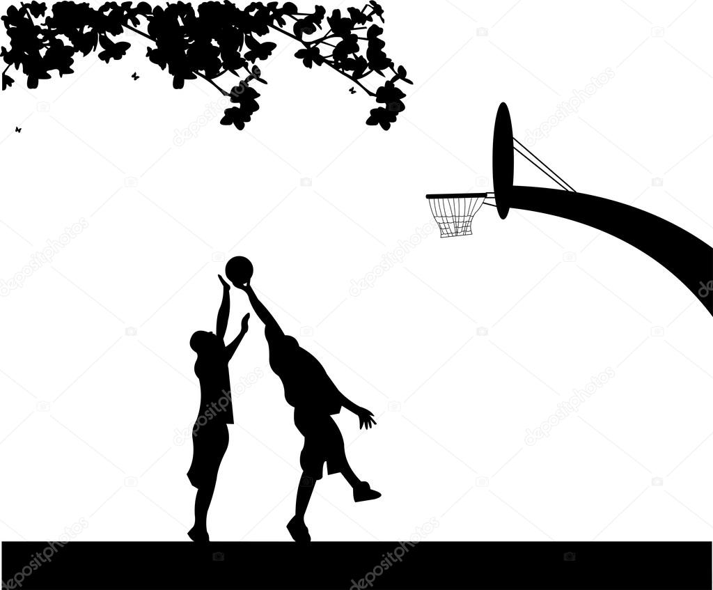 Boys playing basketball outside in spring silhouette