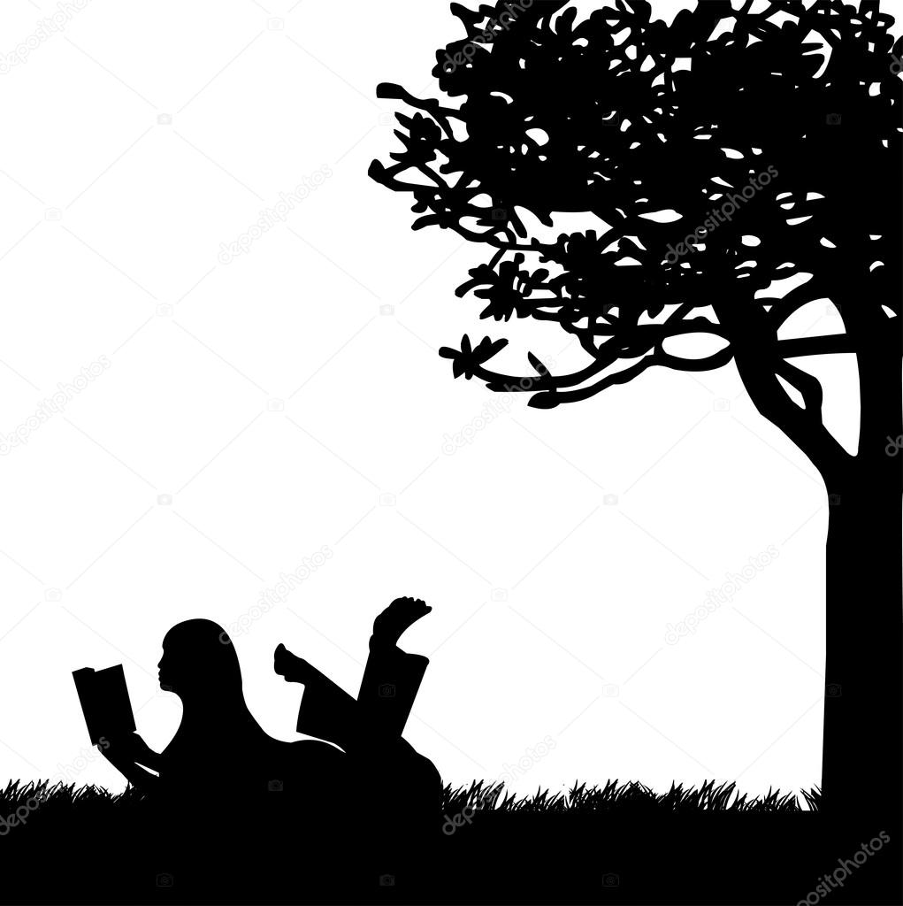 Silhouette of girl reading a book under the tree in spring