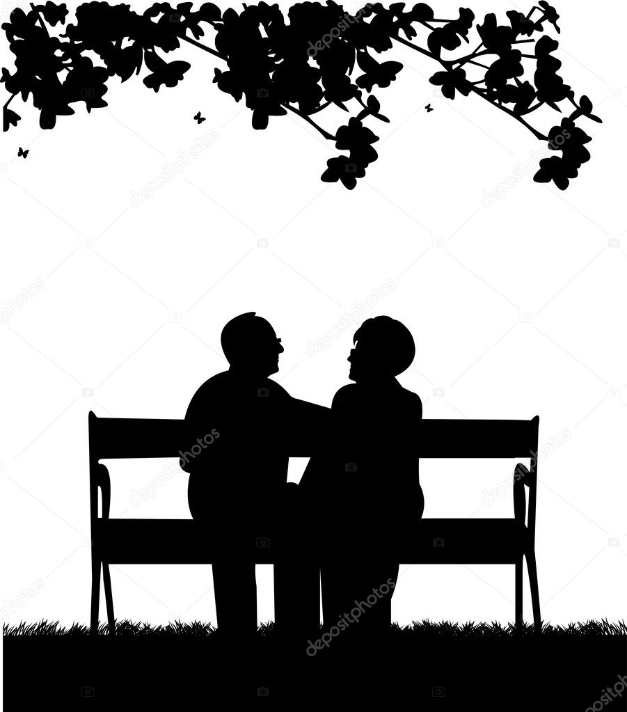 Lovely retired elderly couple sitting on bench in park or garden