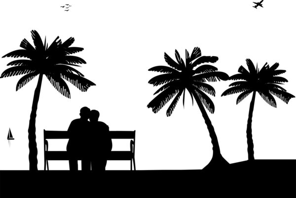 Lovely retired elderly couple sitting on bench on the beach