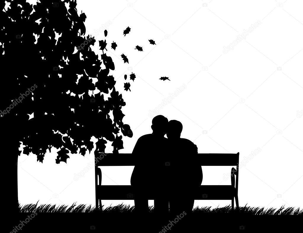 Lovely retired elderly couple sitting on bench in park in autumn or fall