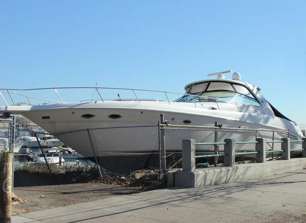 Large boat washed almost to sidewalk in the aftermath of Hurricane Sandy