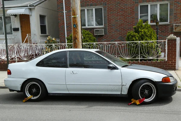 Two wheel locks on an illegally parked car in Brooklyn, NY — Stock Photo, Image