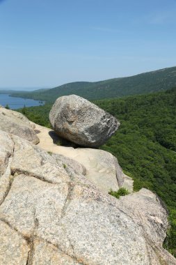 Bubble Rock on top of the South Bubble Mountain and Jordan Pond at Acadia National Park, Maine, USA clipart