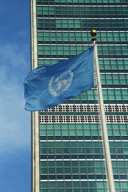 United Nations Flag in front of UN Headquarter in New York clipart