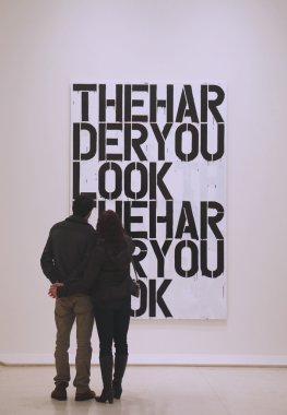 Couple in Solomon R Guggenheim Museum of modern and contemporary art in New York during Christopher Wool exhibition clipart