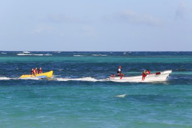 Banana boat riding at the Bavaro Beach in Punta Cana, Dominican Republic clipart
