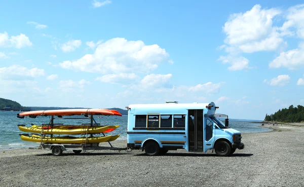 Sea kayaks ready for tourists on land bridge on low tide between Bar Harbor and Bar Island