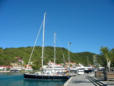Mega yachts in Gustavia Harbor at St. Barts clipart