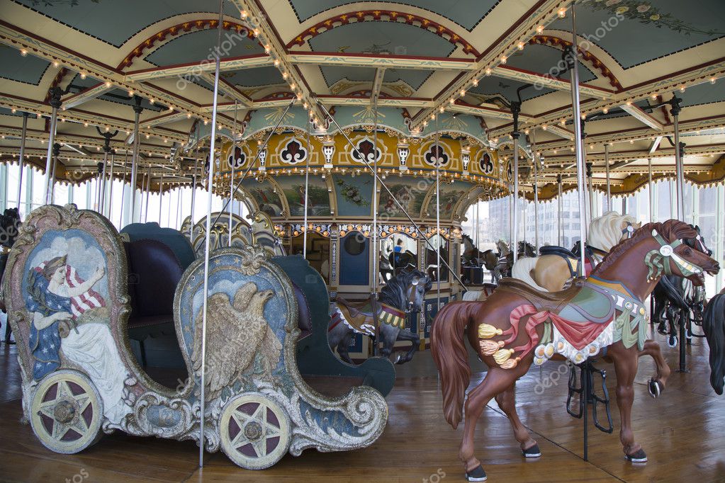 Horses on a traditional fairground Jane's carousel in Brooklyn Stock