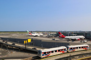 Airport AirTrain in the front of Terminal 4 clipart