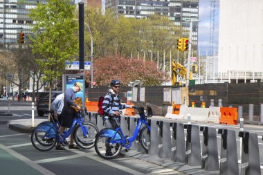 Unidentified bike rider renting Citi bike in Manhattan clipart