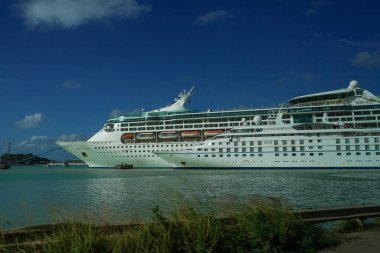 ST. JOHN - ANTIGUA: DECEMBER 30, 2021: A small and a large cruise ship Grandeur of the Seas and Star Legend docking in the port of St. John's in Antigua and Barbuda 