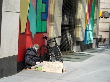 NEW YORK - MARCH 3, 2022: Homeless man at 5th Avenue in Midtown Manhattan