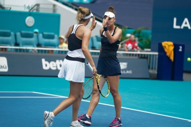 MIAMI GARDENS, FLORIDA - APRIL 3, 2022: Tennis players Veronika Kudermetova of Russia and Elise Mertens of Belgium in action during their women's doubles final match at 2022 Miami Open at the Hard Rock Stadium in Miami Gardens, Florida