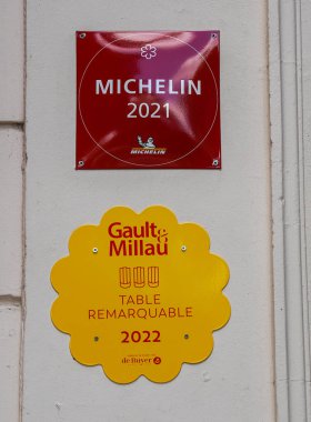 REIMS, FRANCE - MAY 26, 2022: One Star Michelin Guide and Gault Millau French restaurant guide plaques at award-winning Restaurant Le Foch in Reims