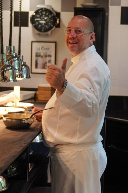 TINQUEUX, FRANCE - MAY 27, 2022: Three Michelin star chef Arnaud Lallement plating at the Three Star Michelin L'Assiette Champenoise restaurant in Champagne Region, France
