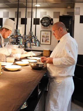 TINQUEUX, FRANCE - MAY 27, 2022: Three Michelin star chef Arnaud Lallement plating at the Three Star Michelin L'Assiette Champenoise restaurant in Champagne Region, France