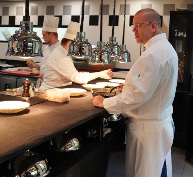 TINQUEUX, FRANCE - MAY 27, 2022: Three Michelin star chef Arnaud Lallement plating at the Three Star Michelin L'Assiette Champenoise restaurant in Champagne Region, France