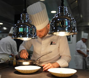 TINQUEUX, FRANCE - MAY 27, 2022: Sous chef plating dish at the Three Star Michelin L'Assiette Champenoise restaurant run by famous Chef Arnaud Lallement in a family run hotel 