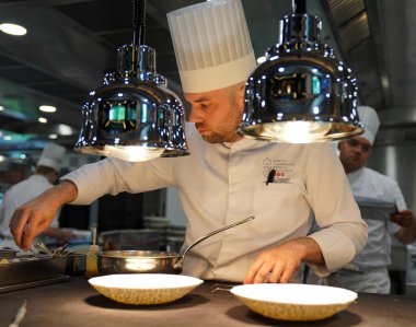 TINQUEUX, FRANCE - MAY 27, 2022: Sous chef plating dish at the Three Star Michelin L'Assiette Champenoise restaurant run by famous Chef Arnaud Lallement in a family run hotel 