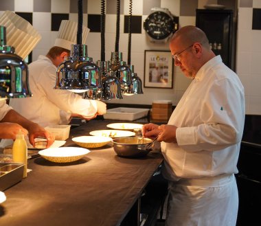 TINQUEUX, FRANCE - MAY 27, 2022: Three Michelin star chef Arnaud Lallement plating at the Three Star Michelin L'Assiette Champenoise restaurant in Champagne Region, France