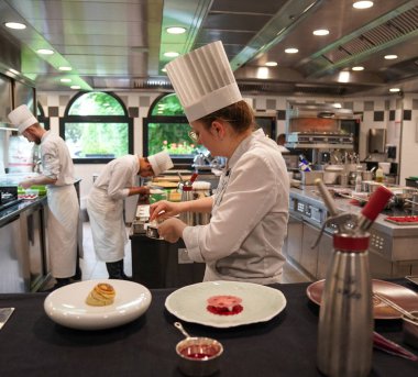 TINQUEUX, FRANCE - MAY 27, 2022: Pastry chef plating dessert dish at the Three Michelin Star L'Assiette Champenoise restaurant run by famous Chef Arnaud Lallement in a family run hotel 