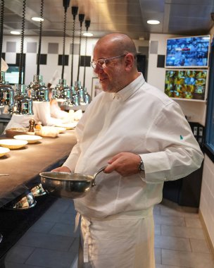 TINQUEUX, FRANCE - MAY 27, 2022: Three Michelin star chef Arnaud Lallement plating at the Three Michelin Star L'Assiette Champenoise restaurant in Champagne Region, France