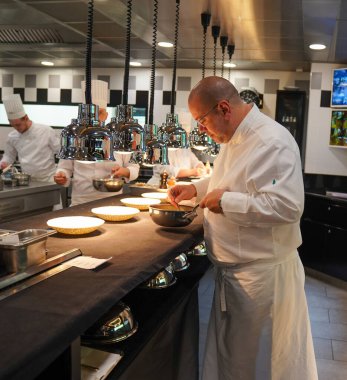 TINQUEUX, FRANCE - MAY 27, 2022: Three Michelin star chef Arnaud Lallement plating at the Three Star Michelin L'Assiette Champenoise restaurant in Champagne Region, France