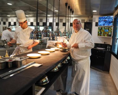 TINQUEUX, FRANCE - MAY 27, 2022: Three Michelin star chef Arnaud Lallement plating at the Three Star Michelin L'Assiette Champenoise restaurant in Champagne Region, France