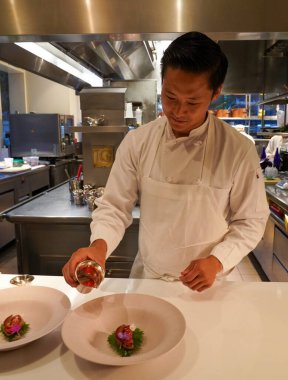 NEW YORK - AUGUST 20, 2022: Chef de Cuisine Joe Rhee plating at Two Michelin Stars Jean-Georges restaurant by French chef Jean-Georges Vongerichten in Manhattan