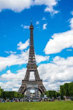 Parisians and tourists having picnic near the Eiffel tower in Paris, France