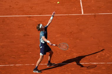 PARIS, FRANCE - JUNE 1, 2022: Professional tennis player Andrey Rublev of Russia  in action during his quarter-final match against Marin Cilic of Croatia at 2022 Roland Garros in Paris, France