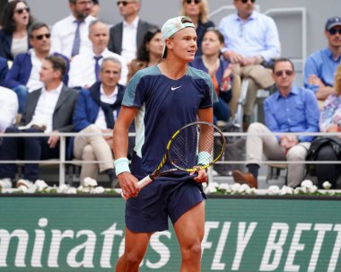 PARIS, FRANCE - MAY 30, 2022: Professional tennis player Holger Rune of Denmark in action during his round 4 match against Stefanos Tsitsipas of Greece at 2022 Roland Garros in Paris, France