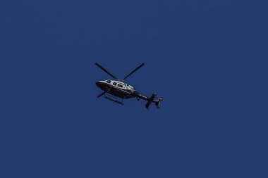 BROOKLYN, NEW YORK - AUGUST 25, 2022: NYPD Bell 429 helicopter in a sky providing security in Brooklyn, New York