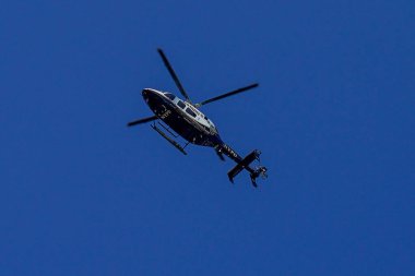 BROOKLYN, NEW YORK - AUGUST 25, 2022: NYPD Bell 429 helicopter in a sky providing security in Brooklyn, New York