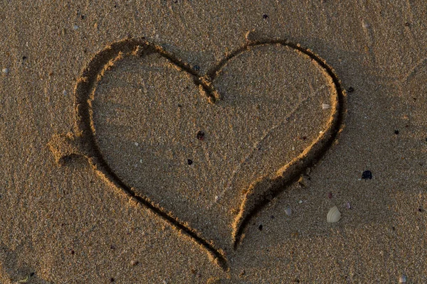 A heart drawn in the sand. Art open air.
