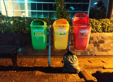 Jakarta, Endonezya - 12 Ocak 2022 Toplum içinde farklı renklere sahip çöp kutusu organik, inorganik ve B3 tehlikeli atıkları ayırmak için.