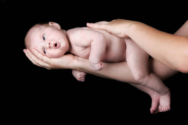 infant on the arm of his mother