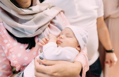 woman holds a sleeping baby tightly in her arms anxiety, experience for the life of a chil