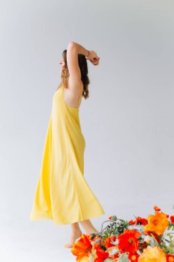 woman in yellow dress emotional dance freedom joy on white backgroun