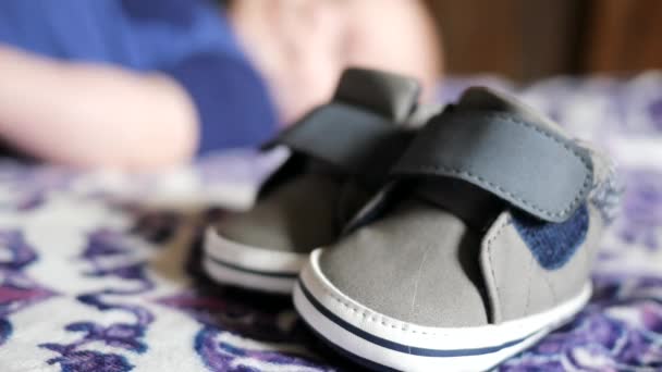 若いです赤ちゃん男の子靴で焦点を当てますブリリー赤ちゃんで背景 — ストック動画