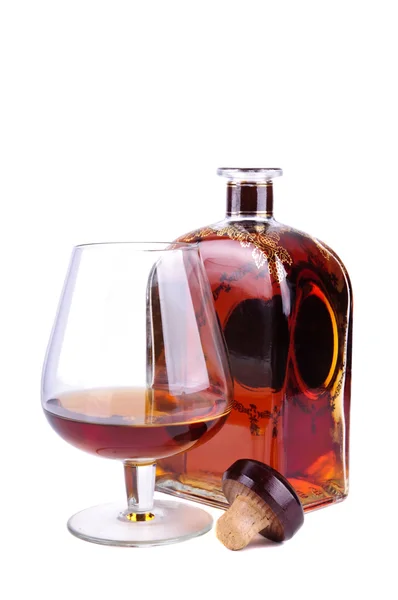 Glas en fles van cognac — Stockfoto