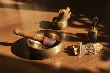 Tibet şarkı kaseleri, çanlar, meditasyon ve ahşap zeminde rahatlama için. Palo Santo ormanı tütsülüyor. Ses masajı ve iyileşme.