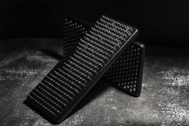 Yakın plan siyah Sadhu tahta tahtaları, yoga için çiviler ve gri arka planda ruhani uygulamalar. Meditasyon konsepti, tırnakların üzerinde durmak, terapi..