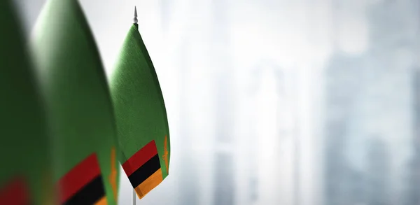 Small flags of Zambia on a blurry background of the city — Stock Photo, Image