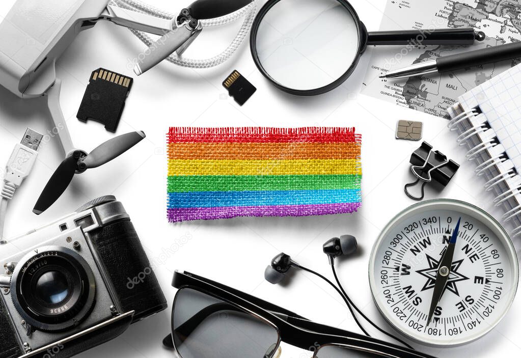 Flag of lgbt and travel accessories on a white background.