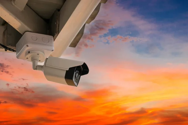 Online Security CCTV camera surveillance system outdoor of house. A blurred night city scape background. Real time Modern CCTV camera on a wall. Equipment system service for safety life or asset.