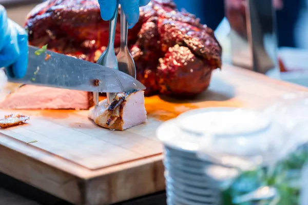 Roast pork neck. Roasted shoulder of pork on a cutting board.